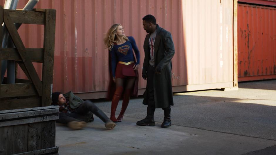 Kara steps around in front of Manchester to keep him from attacking the port supervisor.