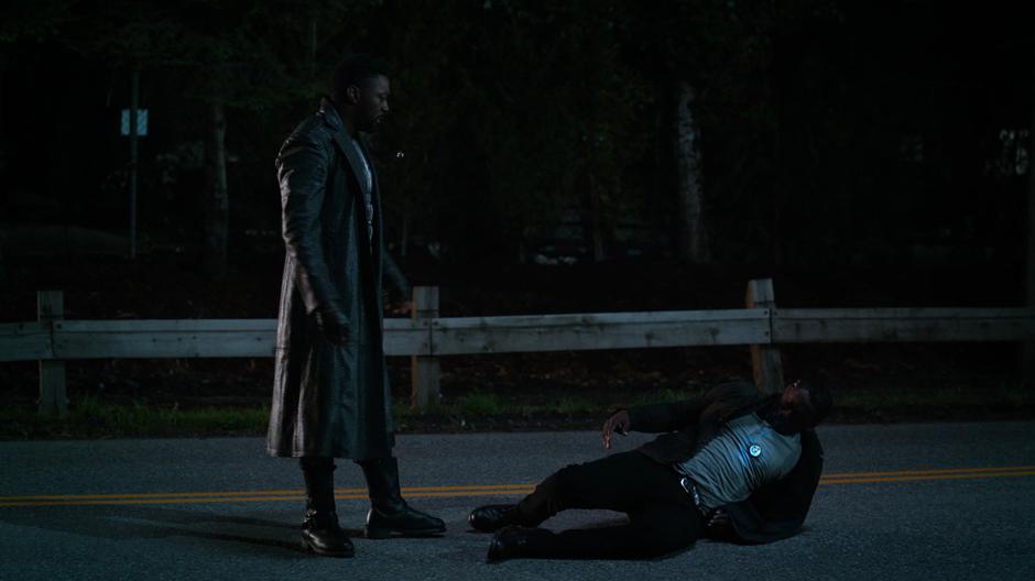 Manchester stands over J'onn after he collapses from the empathy device.