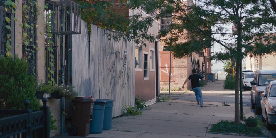 Frank runs around the corner towards his home.