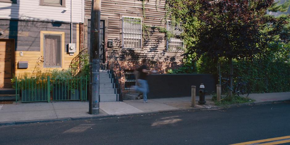 Frank runs down the sidewalk in a blur while holding the pastries.