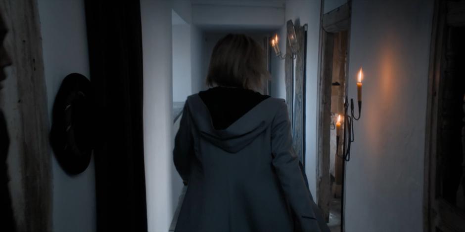 The Doctor walks down the hallway to Becka Savage's bedroom.