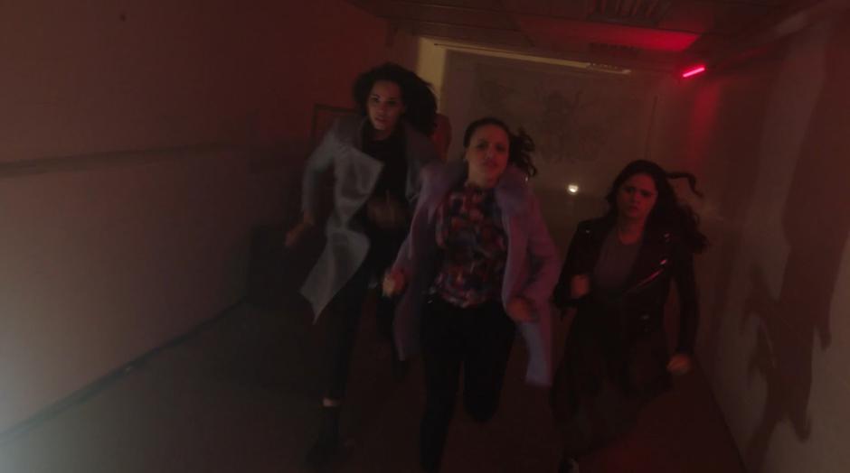 Macy, Maggie, and Mel run down the hallway after Jada.