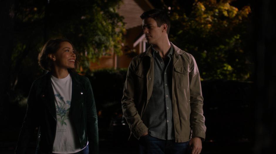 Nora smiles at Barry while they stand across the street.