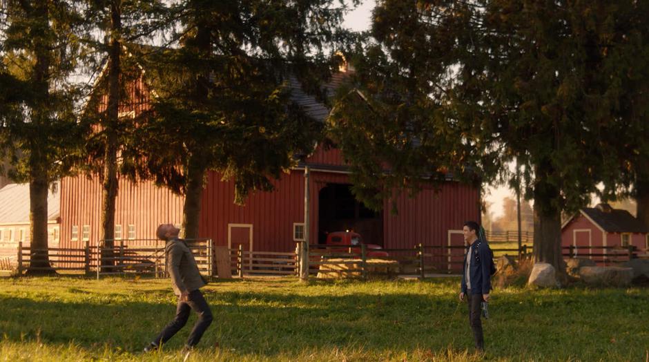 Barry watches as Oliver is hit by two arrows from hidden crossbows.