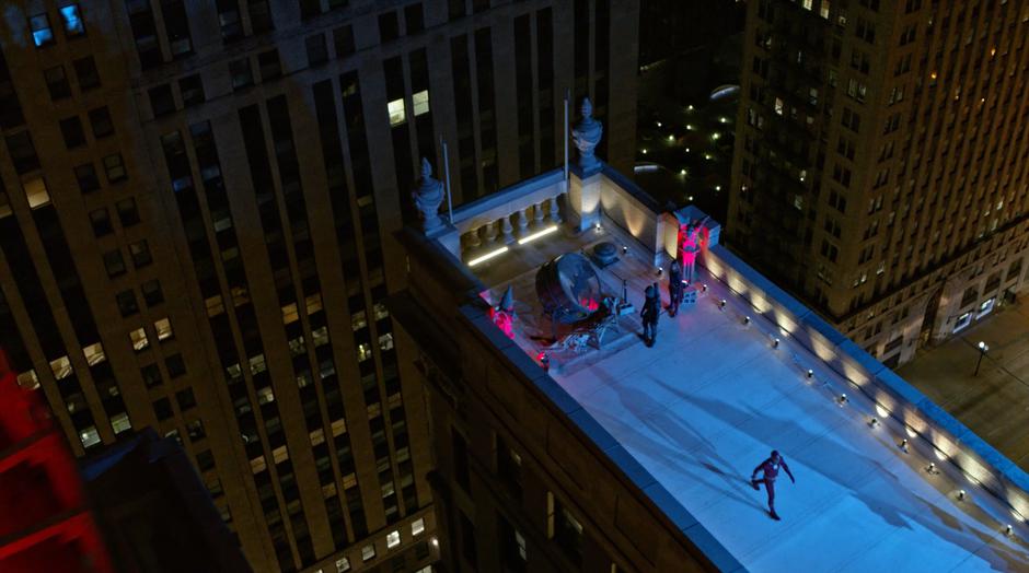 Oliver walks away while Barry and Kara examine the uncovered Bat-Signal.