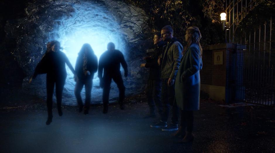 Caitlin, Cisco, and Diggle arrive through a breach in front of Barry, Oliver, and Kara.
