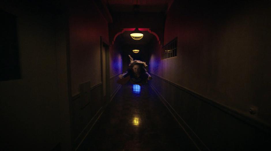 Kara flies down the hallway searching for Dr. Deegan.