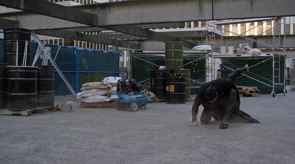 The dark Superman lands dramatically in the construction site.