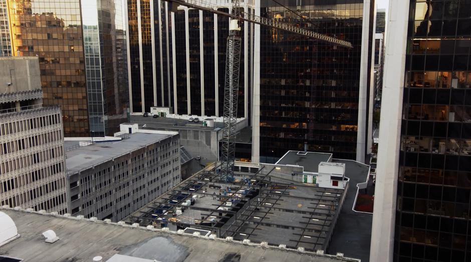 The crane above the construction site beings to fall.