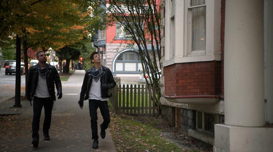 Oliver and Barry walk down the street to Cisco's apartment building.