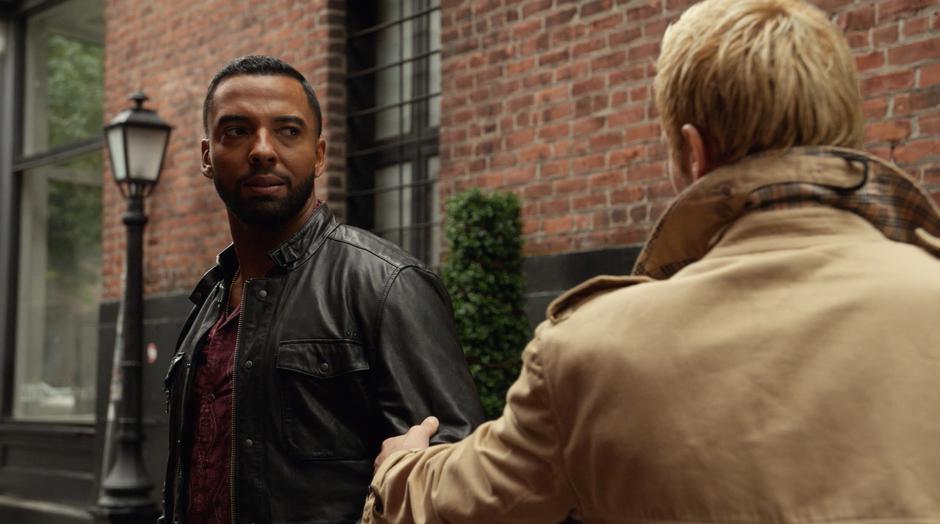 Constantine grabs Des's arm so he can explain his behavior.