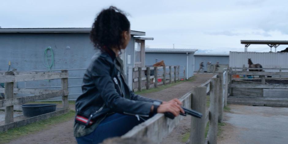 Carly notices two soldiers running past as she climbs over a fence while heading back to the house.