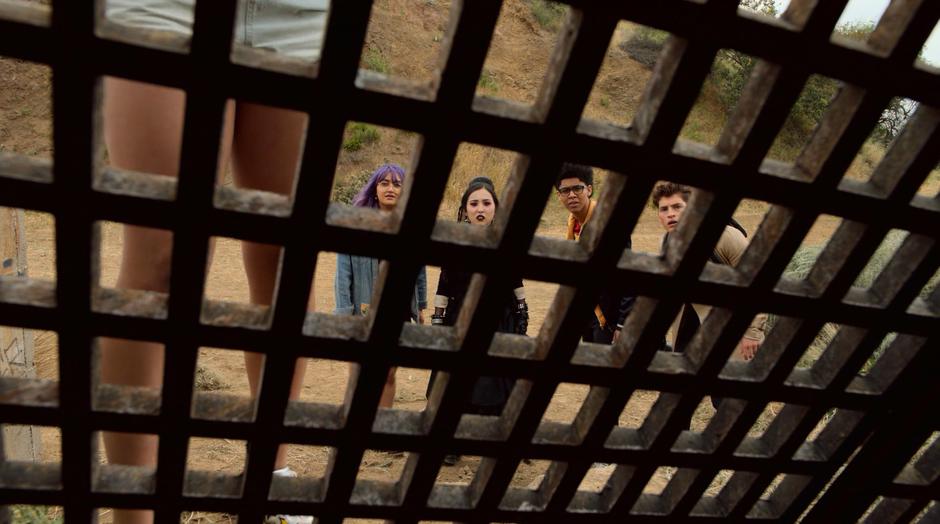 Gert, Nico, Alex, and Chase watch as Molly prepares to rip off the gate.