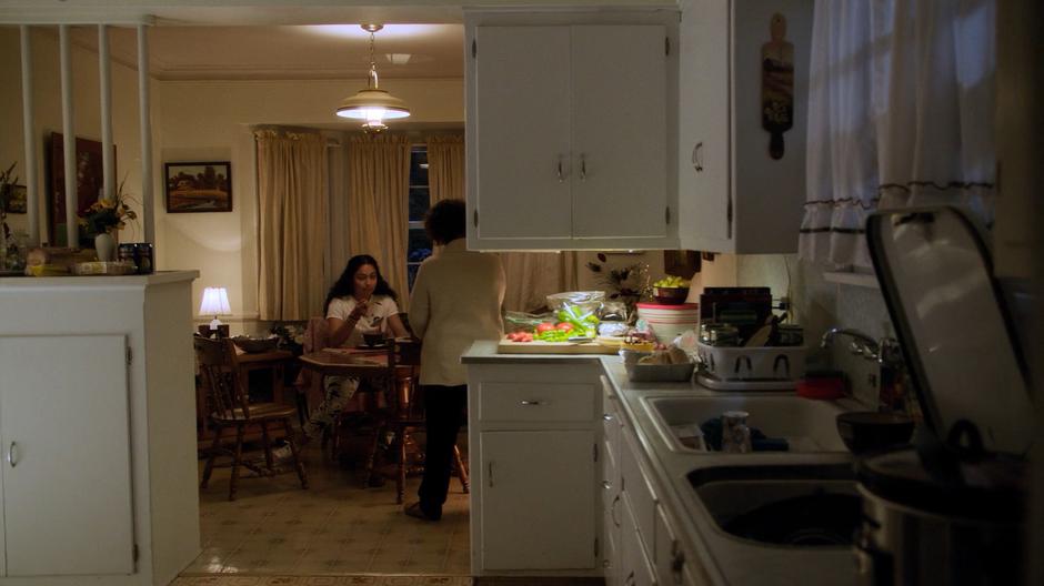 Molly eats some dinner while Graciela Aguirre brings out the box her parents left for her.