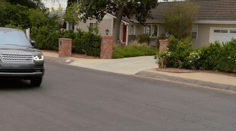 The kids pull up outside the house in their stolen car.