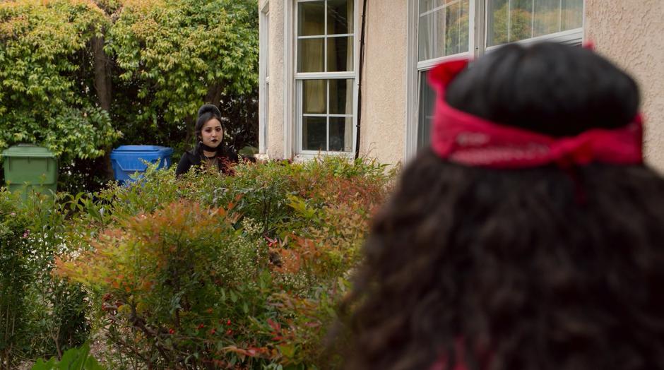 Nico looks over at Molly after seeing Graciela's body through the window.