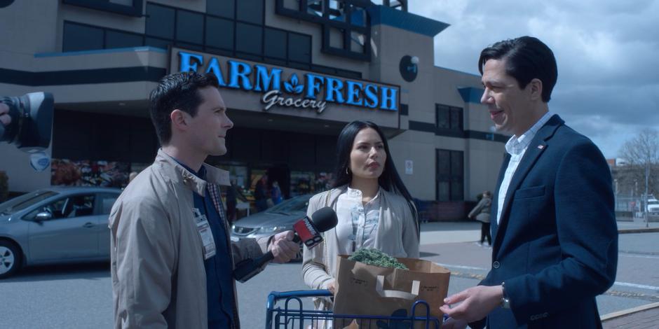 Daniel Sosa stops to dispute the accusations against himself while his wife Katie waits with their groceries.