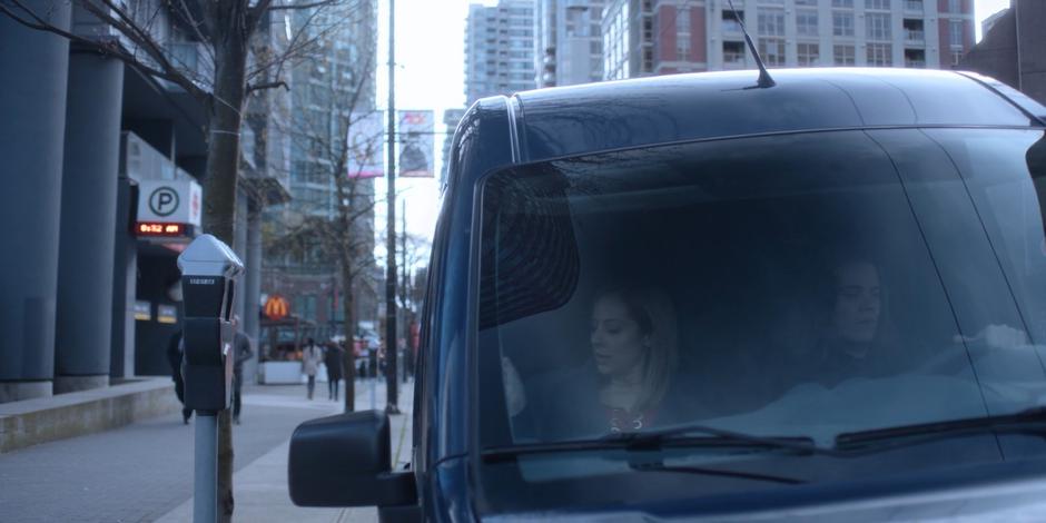 Marcy puts on her seat belt while Philip pulls them out into traffic.