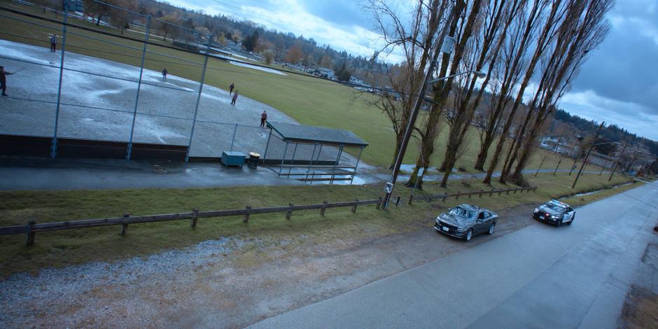 Jeff pulls over to the side of the road and the police car stops behind him.