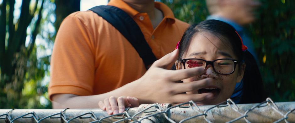 A man tries to cover his daughter's eyes as she is splattered with Wade's blood.