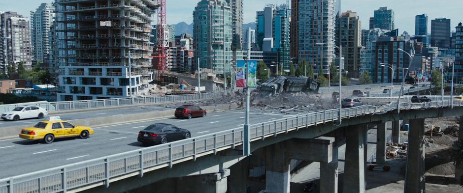 The convoy truck falls through the bridge's surface as it begins to collapse.