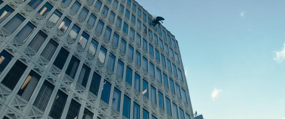 Cable slides down the side of the building leaving a line of debris.