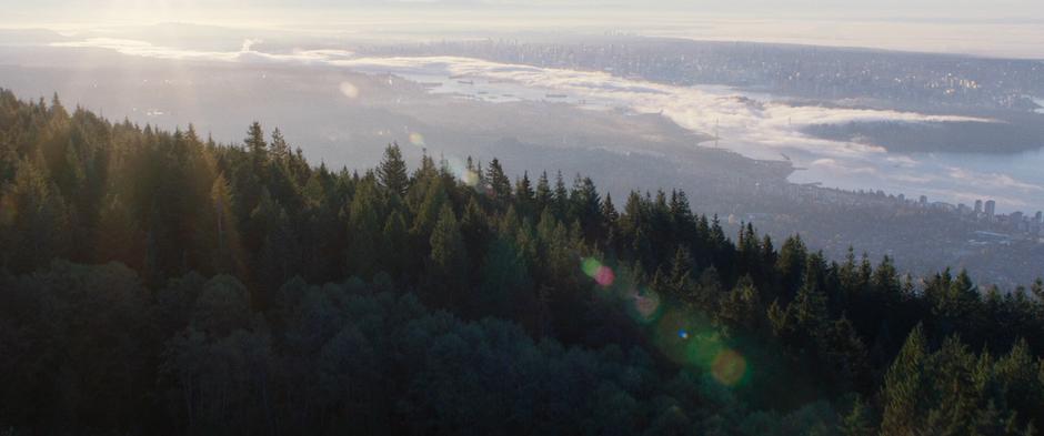 The city is visible in the distance covered by fog.