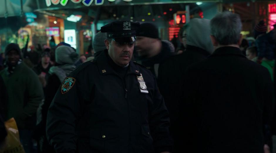 A police officer notices an abandoned duffle bag wihle patroling in the crowd.