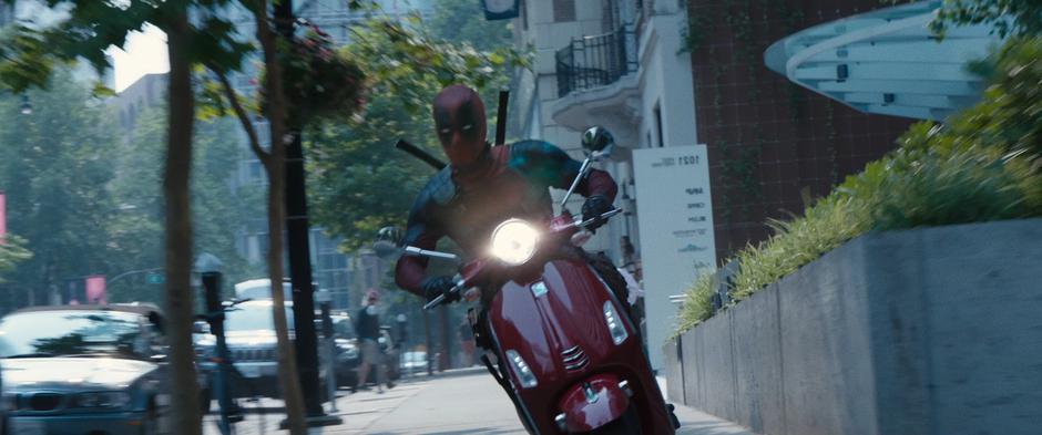 Wade races down the sidewalk on his stolen scooter.