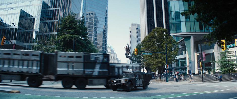 Cable leaps into the air onto the convoy truck as it plows through its leading humvee escort.