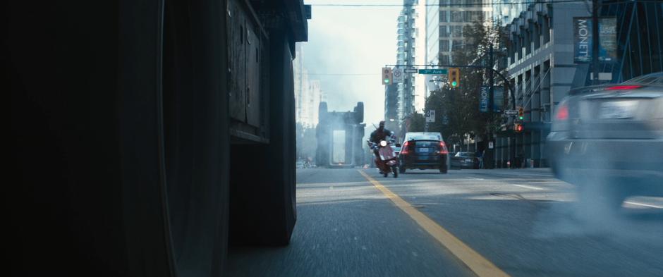 Wade dodges out of the way of the back half of the truck which has flipped over in the middle of the street.