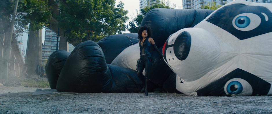 Dominos climbs unharmed from the giant inflatable panda after it catches her fall.