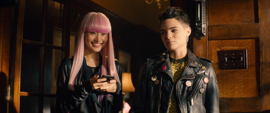 Yukio smiles at Wade while Negasonic Teenage Warhead smiles at her.