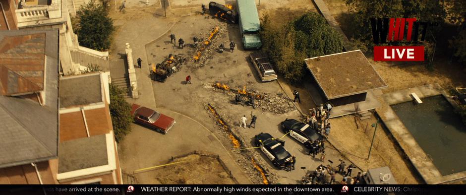 A news helicopter films Russell surrounded by police in front of the facility.