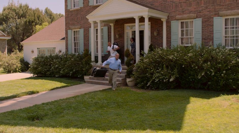 Topher's father throws his suitcase onto the front lawn as Topher runs out to stop him followed by his mother.