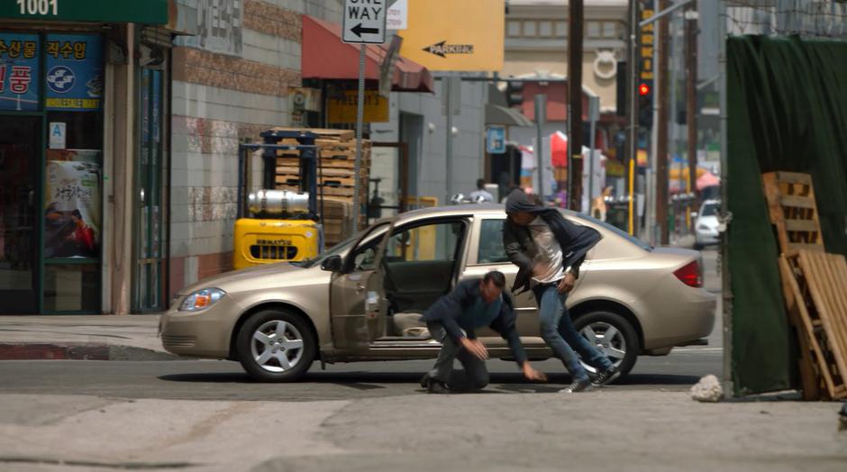 Topher throws a man out of his car to steal it.