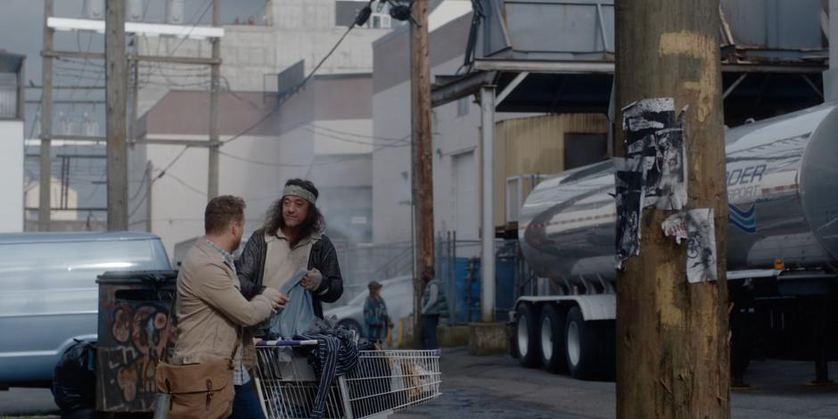 David talks to one of clients in the alley.