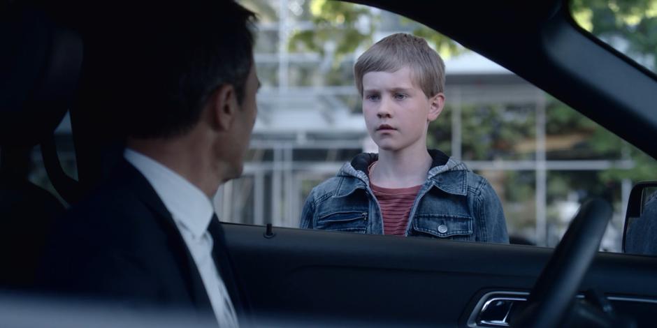 The former Messenger looks confused while standing outside Grant's car.