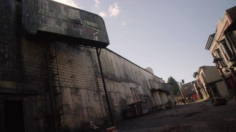 The supply mission walks through a deserted street.