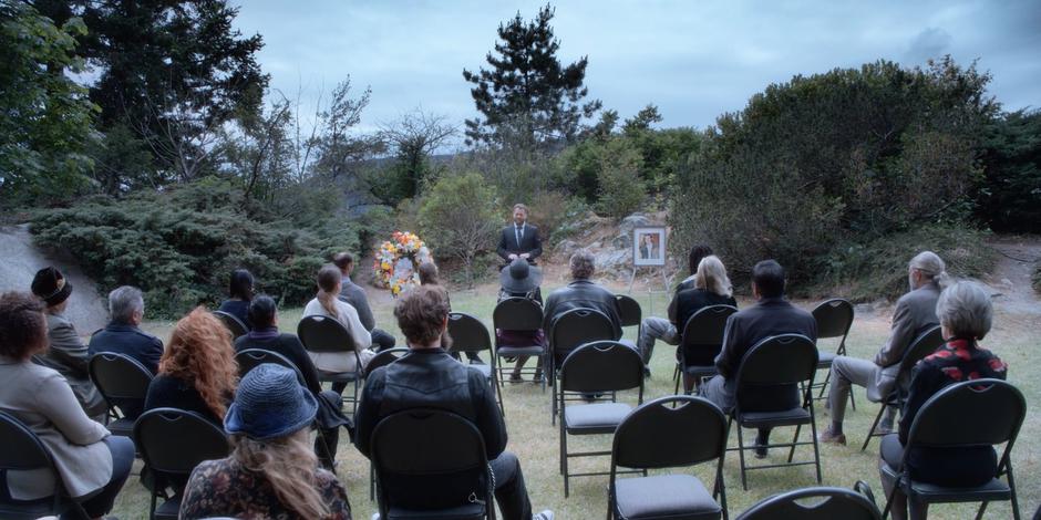 David gives his eulogy for James Edward Bailey in front of a number of people including Marcy.