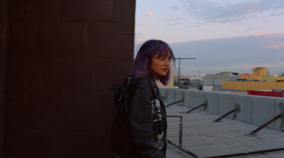 Gert looks around the rooftop after coming out of the access stairwell.