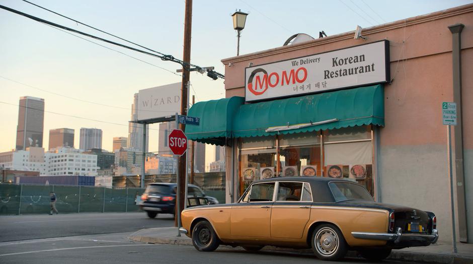 The Runaway's car sits on the street outside the restaurant.