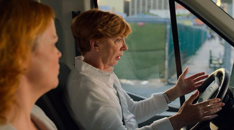 Aura and Frances look down at the wheel as it starts turning without Aura's control.