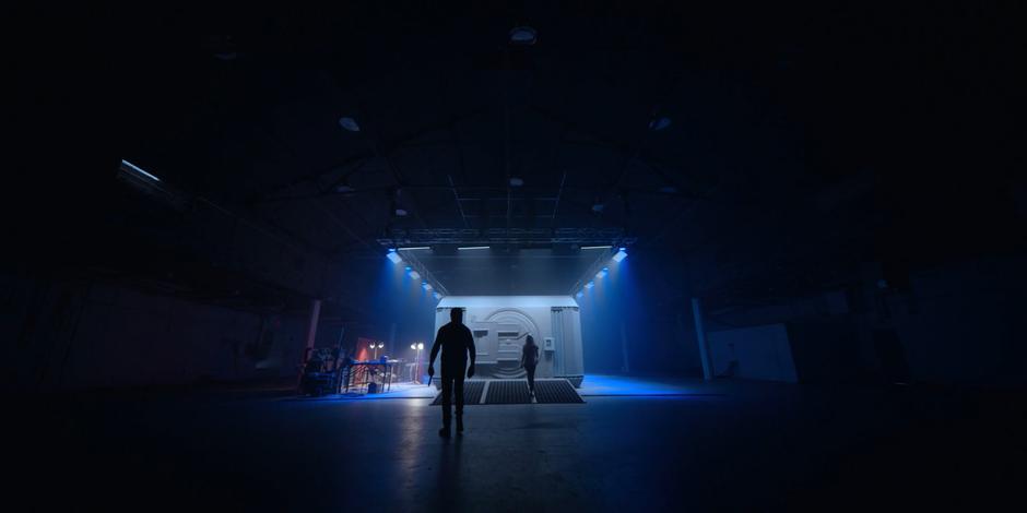 David follows the Archivist towards the sealed vault in the center of the chamber.