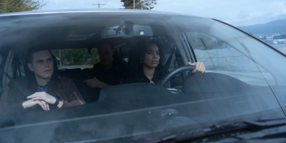 Andrew Graham talks from the back seat while Carly drives and Trevor sits next to her.