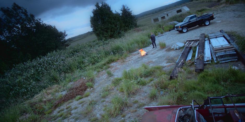 Andrew Graham steps back after his fire starts burning in earnest.