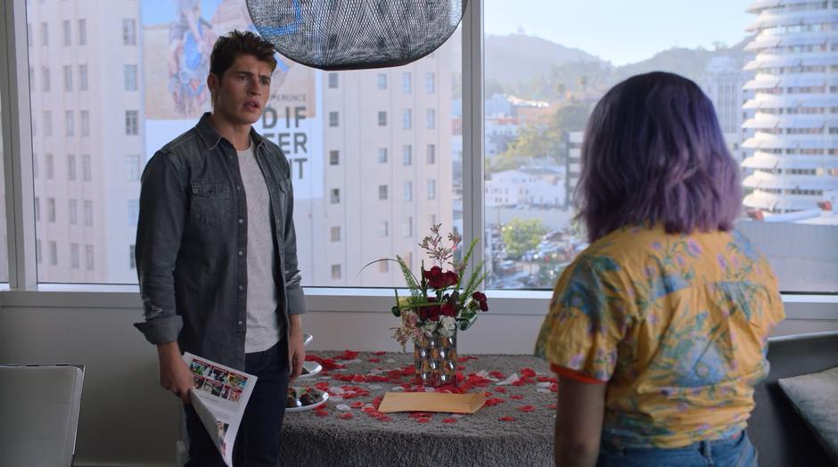 Chase looks at Gert while holding the college application he found.