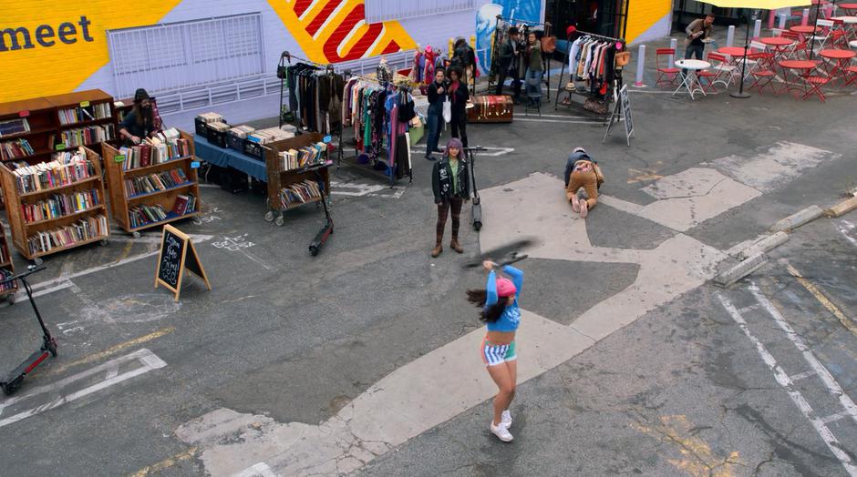 Gert watches as Molly swings the scooter over her head to throw at the drones.