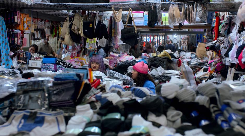 Gert and Molly poke their heads up from behind a pile of clothes where they were hiding.