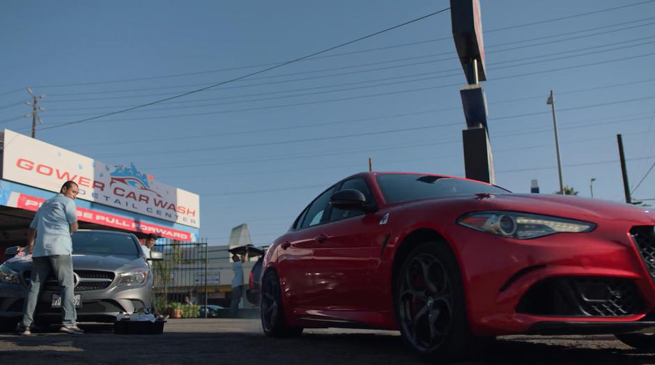 Alex speeds off in a stolen car as the others watch.